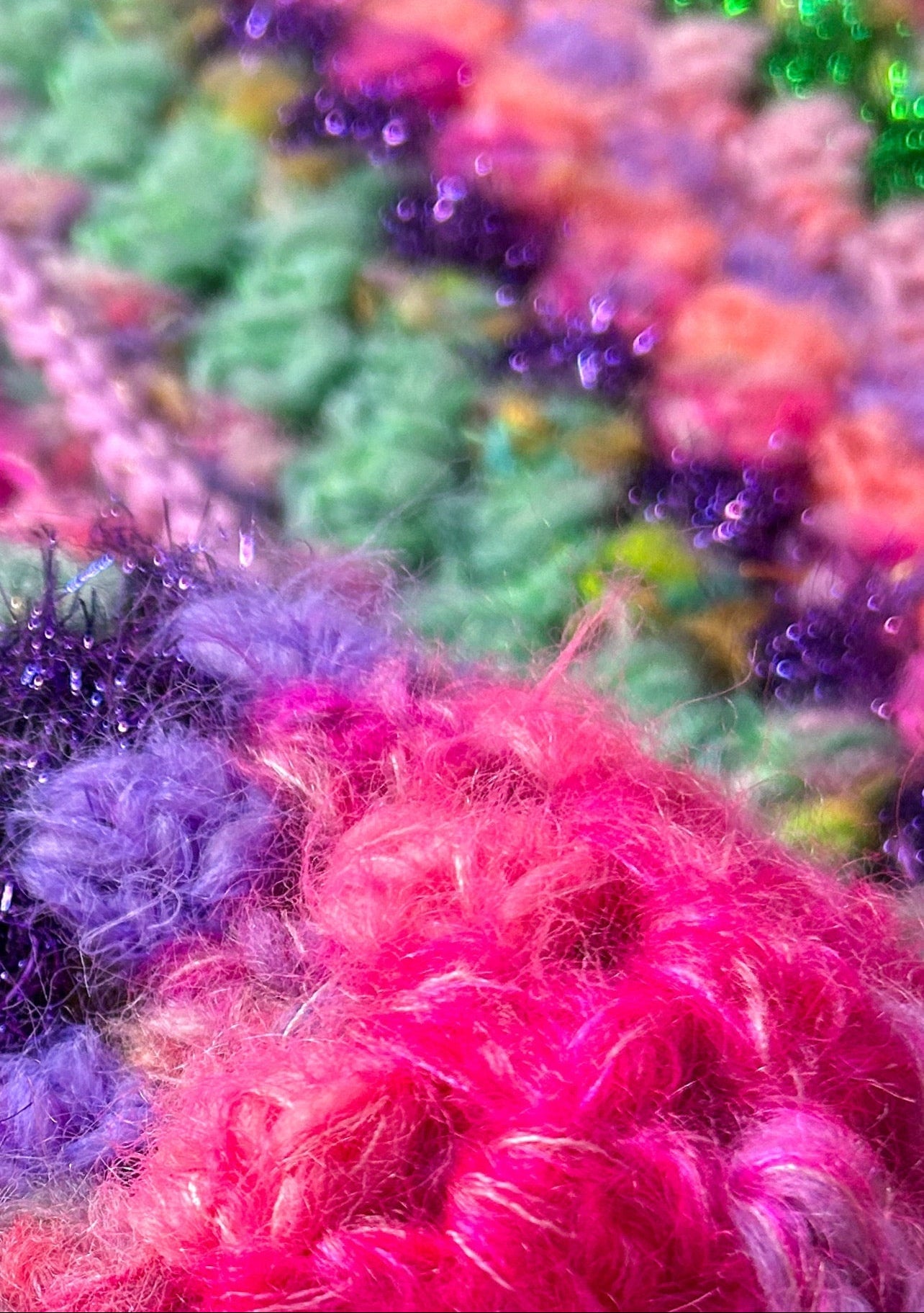 zoom into crochet work with bright colors with glitter yarn